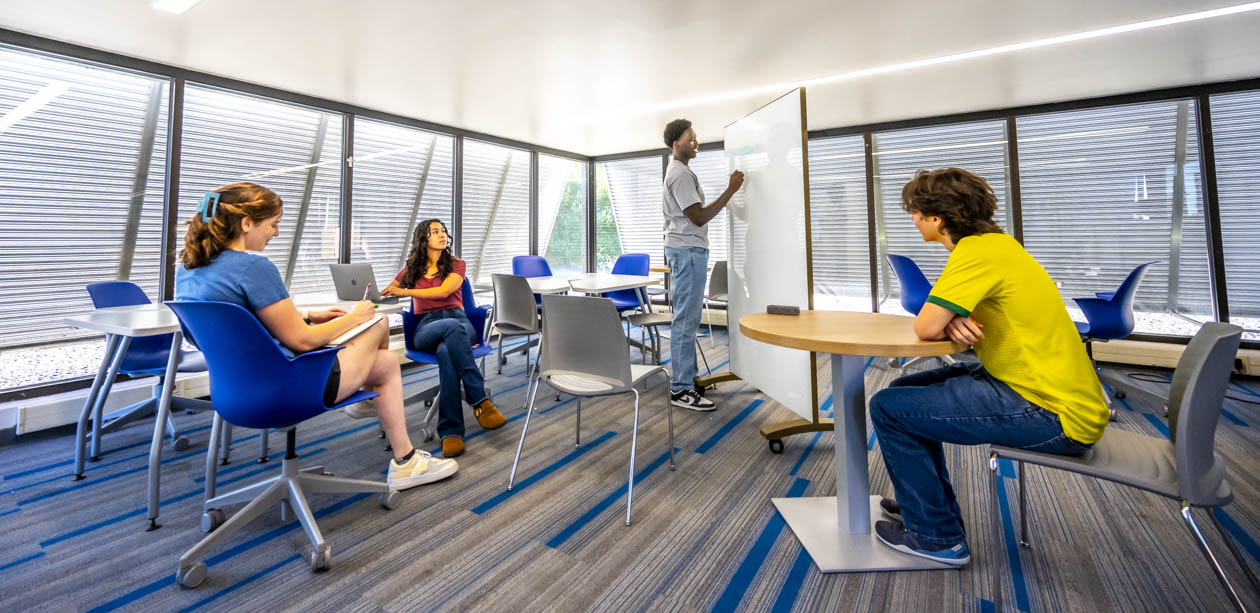 Group of students at St. Mary's University classroom working on project.